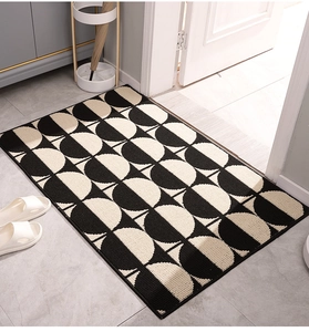 Close-up of modern geometric non-slip door mat with black and white semicircle patterns