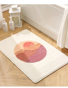 Close-up of thick tufted bath mat texture with artistic sunset mountain pattern design
