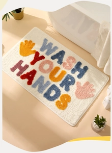 Detailed plush texture of bath mat with Wash Your Hands colorful 3D lettering