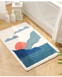 Detail view of the soft absorbent bathroom mat with artistic abstract sun and wave patterns