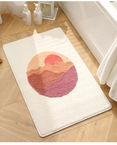 Detailed close-up of a plush non-slip bathroom mat with minimalist sunset mountain design