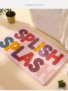 Detail of pink splish splash bath mat showing thick water absorbent tufted fiber texture