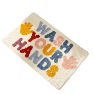 Absorbent rectangular bathroom rug with colorful Wash Your Hands text and palm patterns