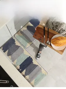 Detail of soft anti-slip kitchen rug set with modern blue wave patterns and plush texture