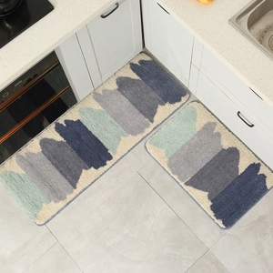 Modern abstract kitchen rug set with deep blue and mint green patterns on kitchen floor