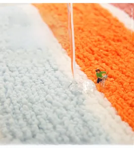 Macro view of striped microfiber bath mat showing instant water absorption technology