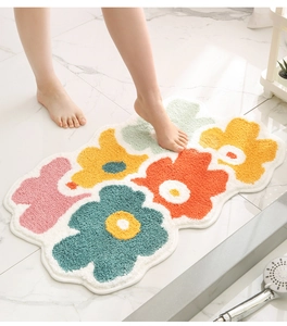 Detail of colorful floral flocking bath mat with thick absorbent pile for home bathroom