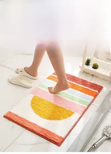 Detail of plush cream-style bathroom rug with colorful geometric semicircles and stripes