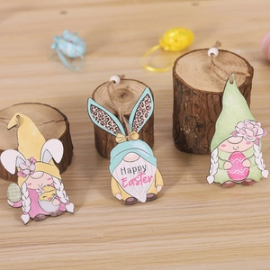 Detailed view of three painted wooden Easter gnomes with rabbit ears and hanging beads
