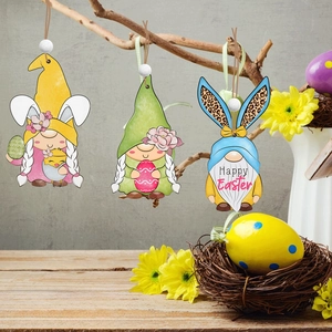 Three Easter gnome wooden pendants with bunny ears and floral details hanging on dry branches