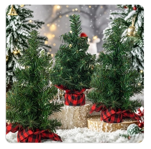 Miniature artificial Christmas trees with red plaid base wraps for festive tabletop decor