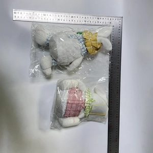 Size measurement of plush Easter bunnies in plastic packaging showing 30cm length
