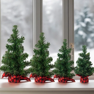 Mini artificial Christmas trees with red plaid bases on a snowy window sill decor