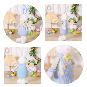 Detail view of Easter bunny plush in blue striped shirt and corduroy overalls decoration