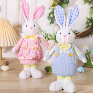 Detailed close-up of Easter plush bunnies in floral dress and blue corduroy overalls