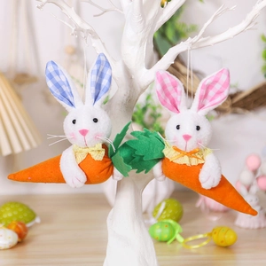 Close-up of Easter plush bunny pendant hanging on a branch with a carrot detail