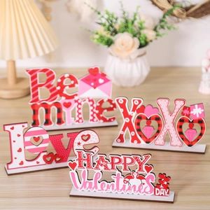 Detail of four Valentine's Day wooden tabletop signs with Love and XOXO heart designs