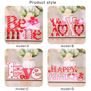 Set of four wooden Valentine's Day desk ornaments featuring heart designs and festive text