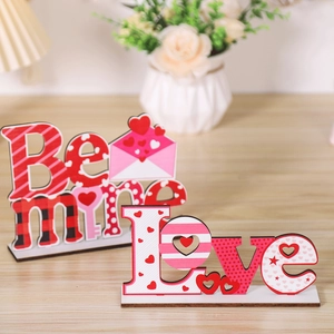 Detail of Be Mine and Love wooden Valentine ornaments with red heart patterns
