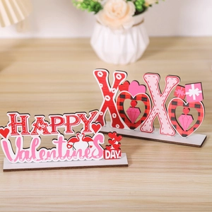 Macro detail of wooden Valentine's Day XOXO and Happy Valentine's Day signs for table