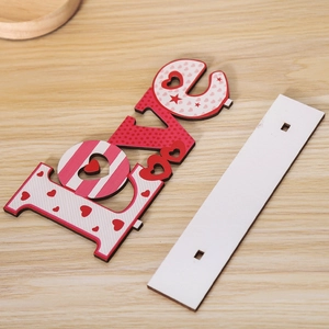 Detail view of LOVE wooden letter block with heart patterns and a white mounting base