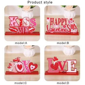 Detail of four Valentine wooden table signs with glitter accents and sturdy red bases