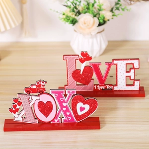 Detail of wooden LOVE and XOXO tabletop signs with glitter hearts for Valentine decor
