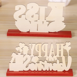 Detail of wooden Valentine's Day tabletop signs with Kiss Me and Happy Valentine's text
