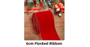 Close-up of 6cm red velvet ribbon with gold edges on festive wooden background