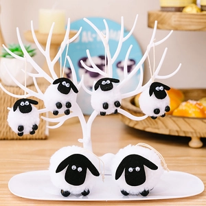Detail of cute plush lamb hanging ornaments made of soft white wool and black felt accents
