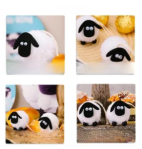 Detail of plush lamb hanging ornaments with black felt heads and white fuzzy fleece texture