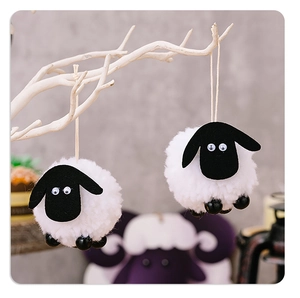 Detailed view of fluffy white lamb ornaments with black felt heads on white tree branches