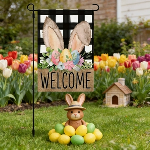 Detail of Easter garden flag featuring rabbit ears and colorful eggs in flower garden