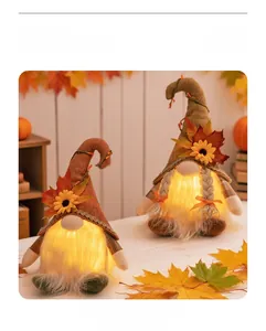 Close-up of lighted Thanksgiving gnomes with autumn maple leaves and sunflowers