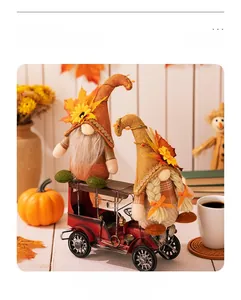 Detail of harvest gnomes with maple leaf and sunflower on a vintage red metal truck toy