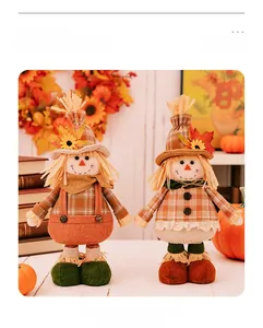 Macro detail of Thanksgiving scarecrow gnome dolls with maple leaf and sunflower decor