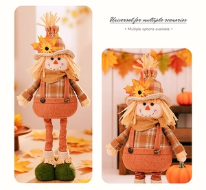 Close-up of autumn scarecrow doll with sunflower hat and orange overalls