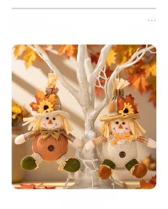 Detail of handmade scarecrow doll pendants with burlap texture and autumn leaf motifs