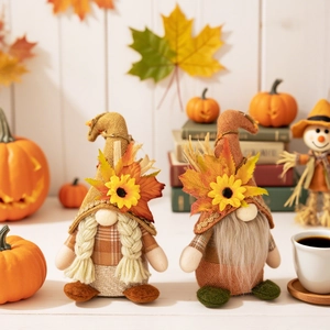Pair of autumn gnome plush ornaments with sunflowers, maple leaves, and orange plaid details