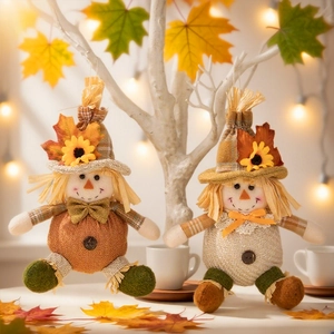 Harvest Thanksgiving scarecrow ornaments with maple leaf and sunflower details on warm background