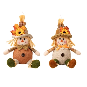 Pair of handmade autumn scarecrow dolls with sunflowers and maple leaves for Thanksgiving
