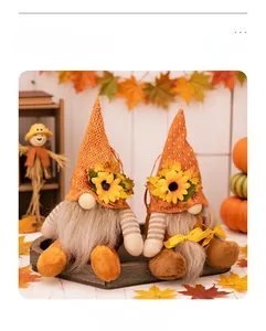 Detailed close-up of knitted orange hats with sunflower and maple leaf on fall gnomes