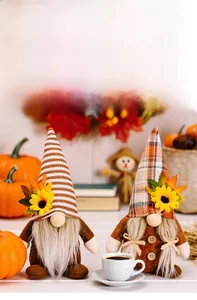 Close-up of autumn gnomes with sunflowers and maple leaves for harvest festival decor