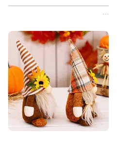 Close-up of autumn harvest gnomes with sunflowers and maple leaves in a warm home setting