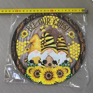 Detail of round wooden Bee Our Guest plaque showing the 20cm diameter measurement