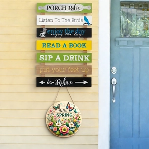 Detail of wooden Hello Spring and Porch Rules signs hanging on a rustic wooden wall