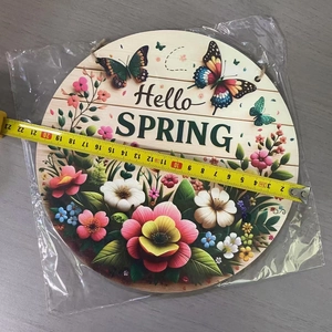 Detail of 23cm wooden Hello Spring sign with floral and butterfly motifs in packaging