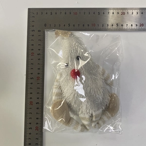 Close-up of a plush Christmas gnome with white faux fur beard and gold sequined hat
