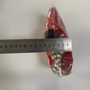 Detailed view of plush Christmas ornament in packaging with measuring scale showing 7cm width