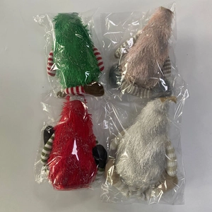 Detailed set of four plush Christmas gnomes in green, pink, red, and silver festive colors